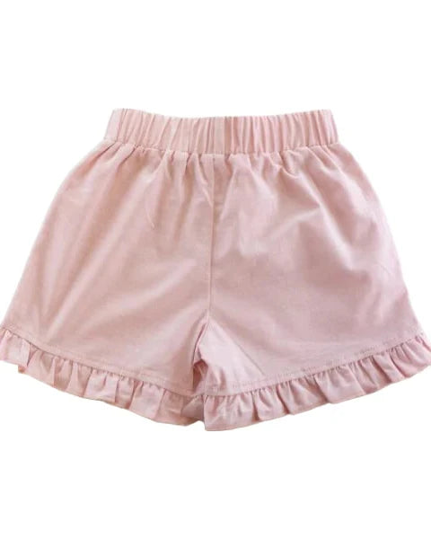 Pink shorts with ruffled edges on a white background