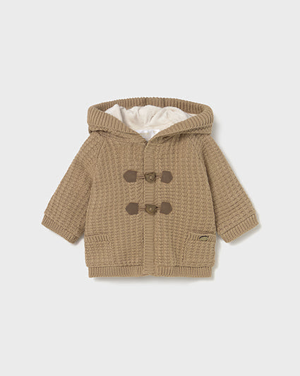 Brown knitted baby coat with hood and button details on a white background