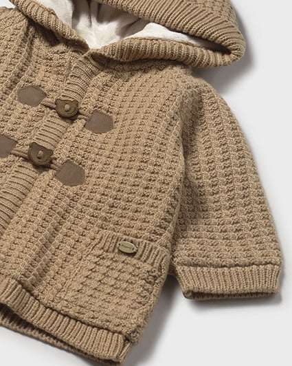 Brown knitted baby sweater with buttons on a white background