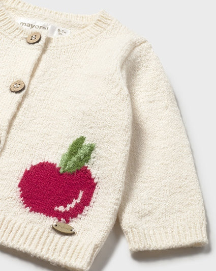 Knitted sweater with a red apple design on a white background