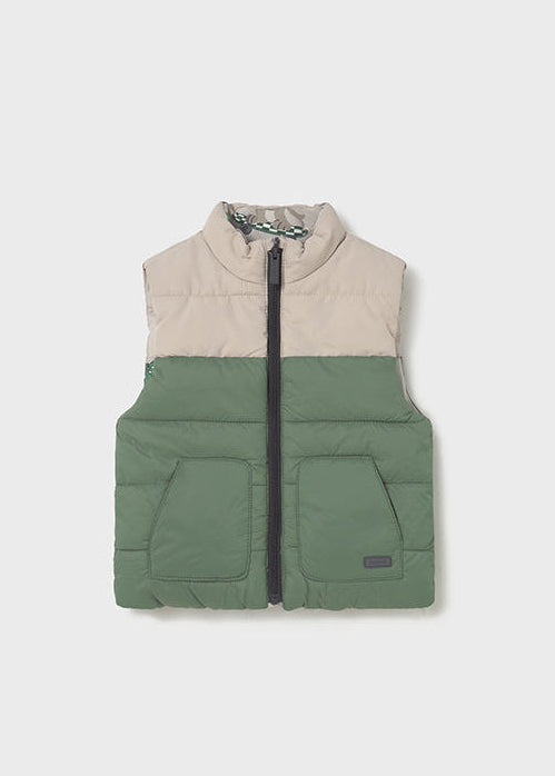 Two-tone puffer vest with beige top and green bottom on a white background