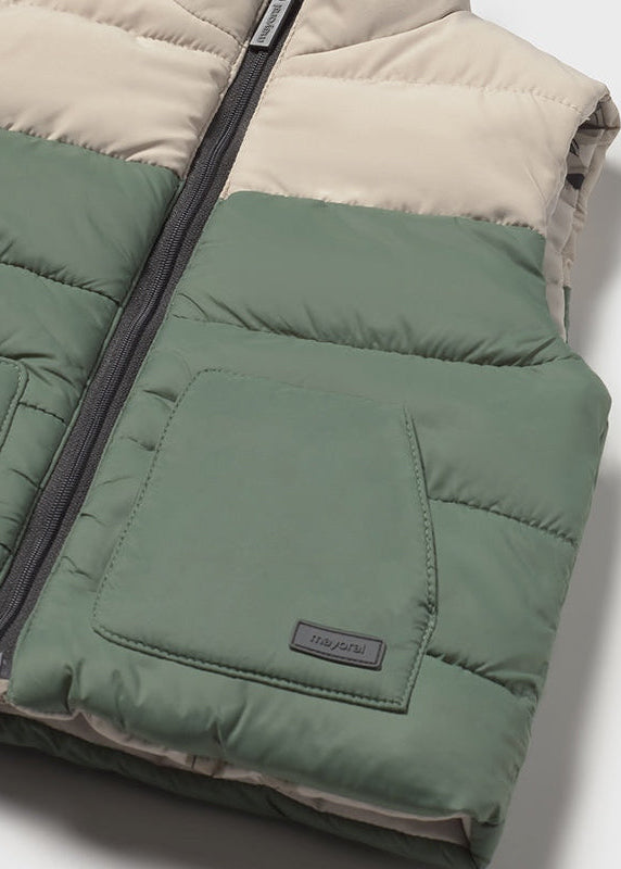 Green and beige puffer vest with a brand label on a light gray background
