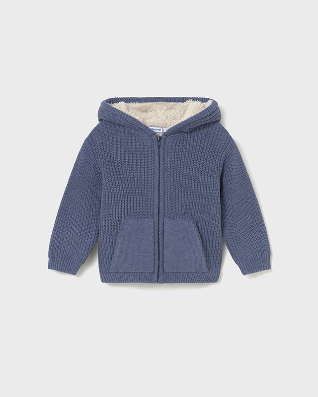 Blue knitted hoodie with a hood on a light gray background