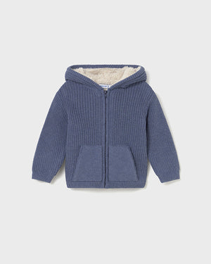 Blue knitted hoodie with a hood on a light gray background
