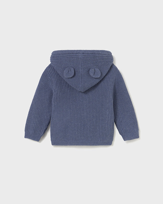 Blue knitted hoodie with ear-shaped buttons on a light gray background