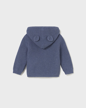 Blue knitted hoodie with ear-shaped buttons on a light gray background
