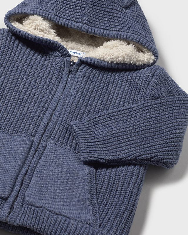 Blue knitted hoodie with sherpa lining on a white background