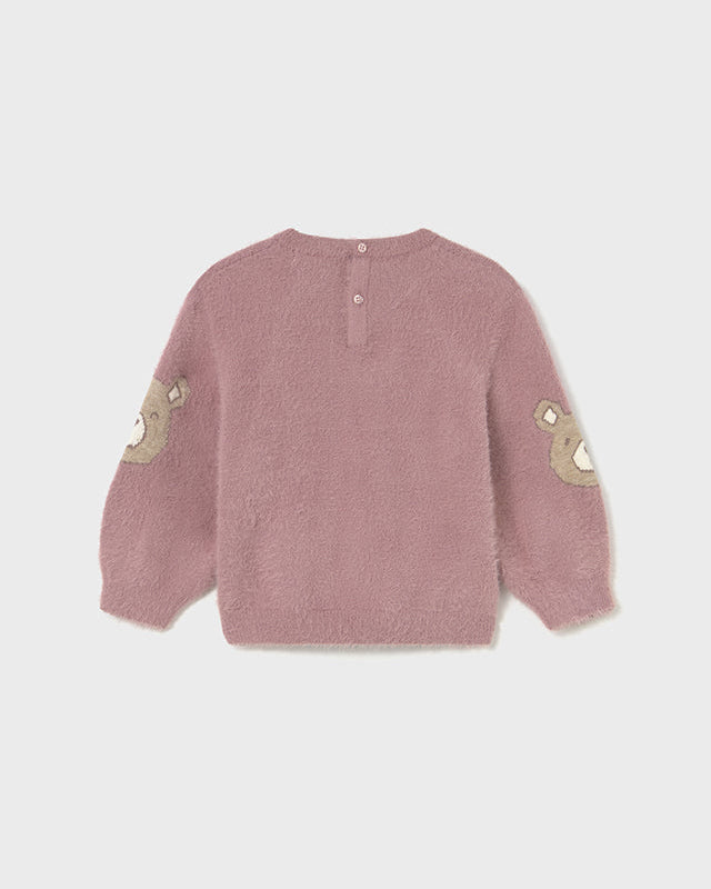 Pink textured sweater with beige accents on a white background