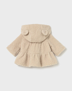 Beige baby coat with a hood on a light gray background