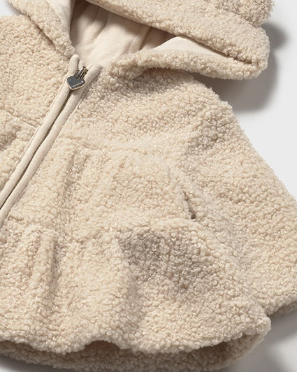 Close-up of a beige fleece jacket with a zipper on a white background