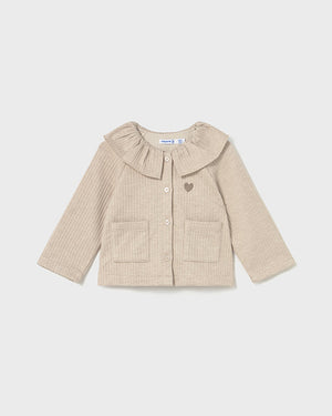 Beige ribbed sweater with a frilled collar on a white background
