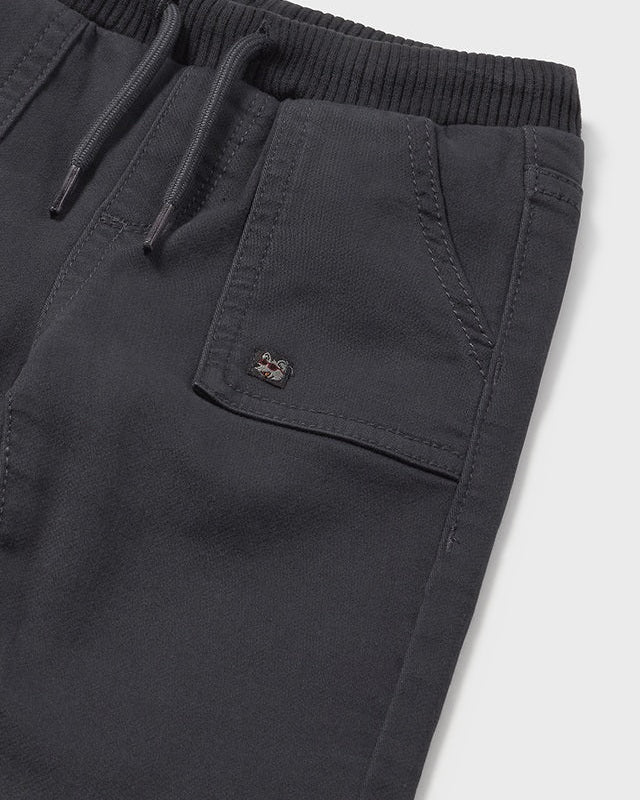 Dark gray shorts with a brand logo on a white background
