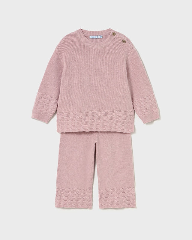 Pink textured sweater and pants set on a light pink background