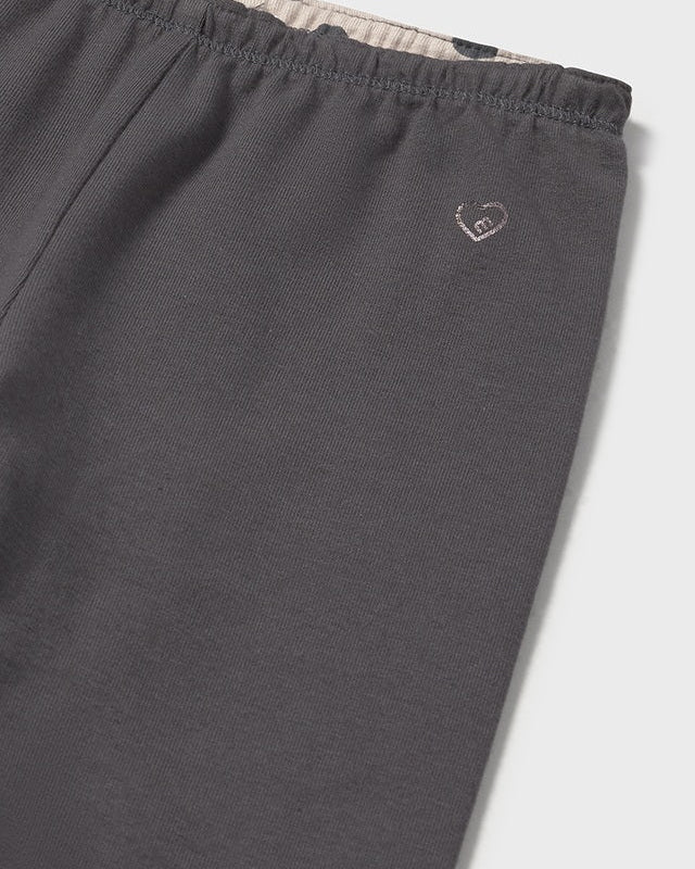 Dark gray pants with a small logo on a light gray background
