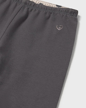 Dark gray pants with a small logo on a light gray background