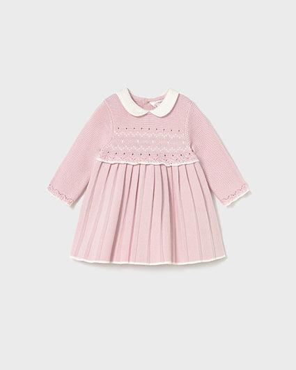 Pink dress with white collar on a light gray background