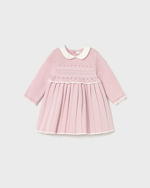 Pink dress with white collar on a light gray background