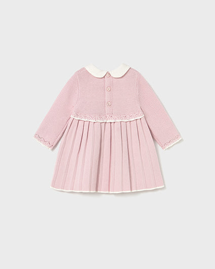 Pink dress with a white collar on a light gray background