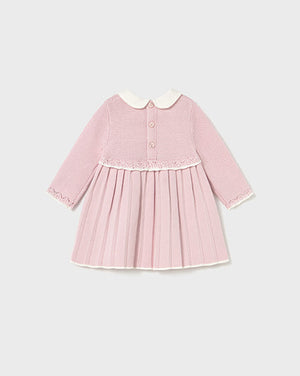 Pink dress with a white collar on a light gray background