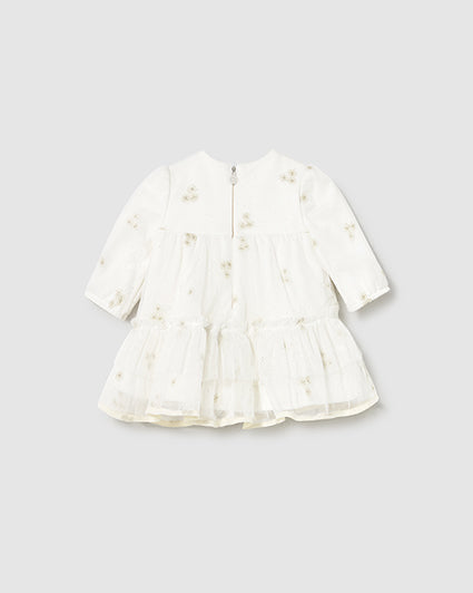 White dress with floral patterns on a light gray background