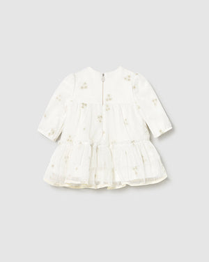 White dress with floral patterns on a light gray background
