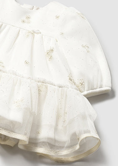 White dress with floral embroidery on a light gray background