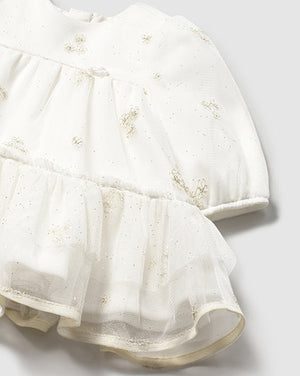 White dress with floral embroidery on a light gray background