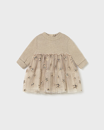 Beige baby dress with floral embroidery on a white background
