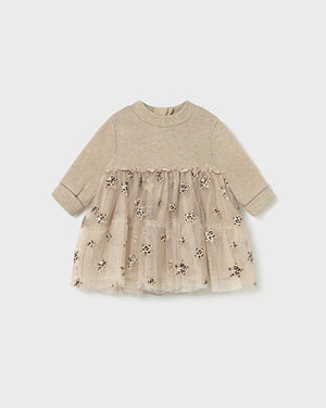 Beige baby dress with floral embroidery on a white background