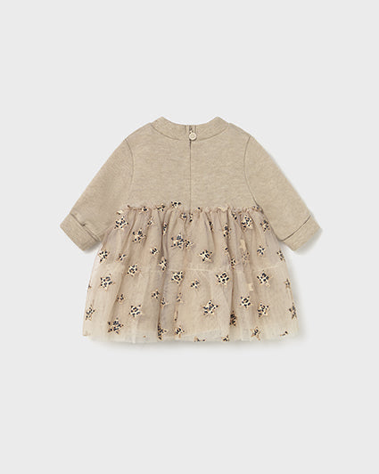 Baby dress with floral pattern on a light gray background