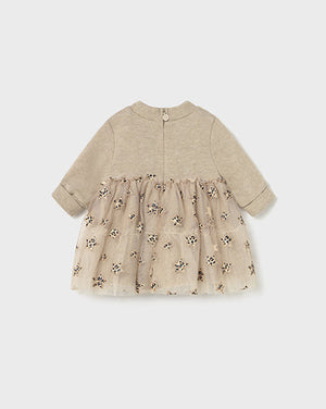 Baby dress with floral pattern on a light gray background