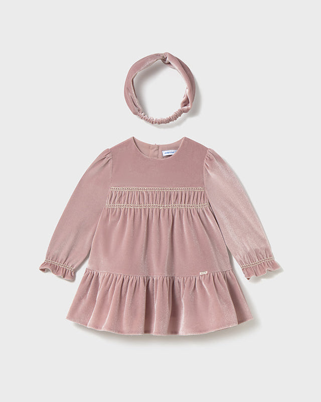 Pink dress and headband set on a light gray background
