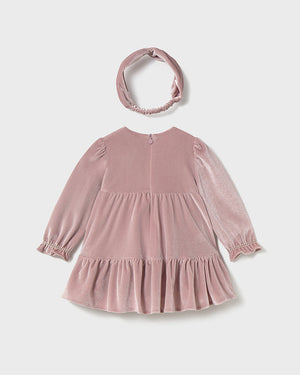 Pink velvet dress with long sleeves and a matching headband on a white background