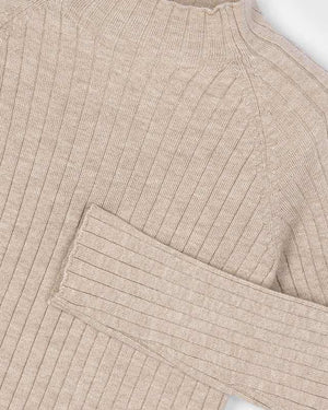 Close-up of a beige ribbed sweater on a white background
