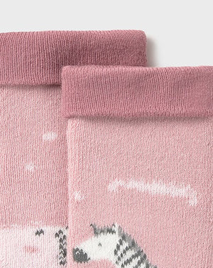 Pair of pink tights with zebra design on a light pink background