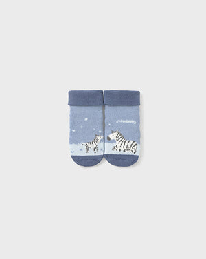 Pair of baby socks with zebra design on a light gray background
