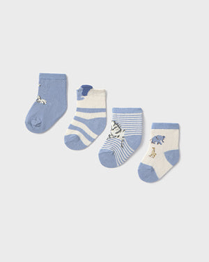Set of four baby socks with animal designs on a light gray background