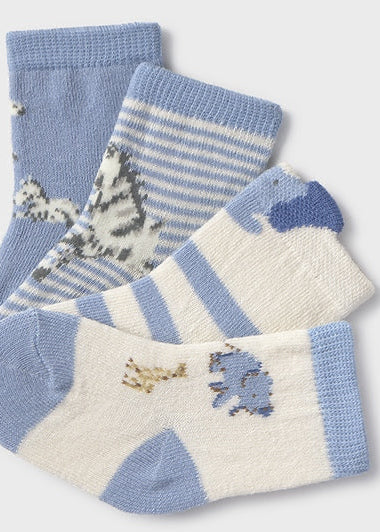 Set of three pairs of baby socks with animal patterns on a light gray background