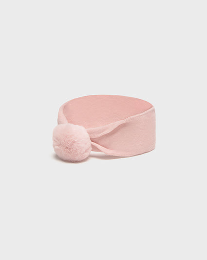 Pink headband with a pom-pom on a light gray background