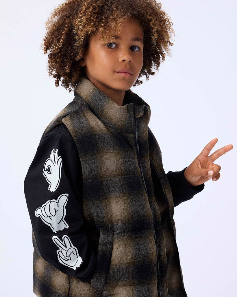 Child wearing a plaid coat with peace sign designs on sleeves against a white background