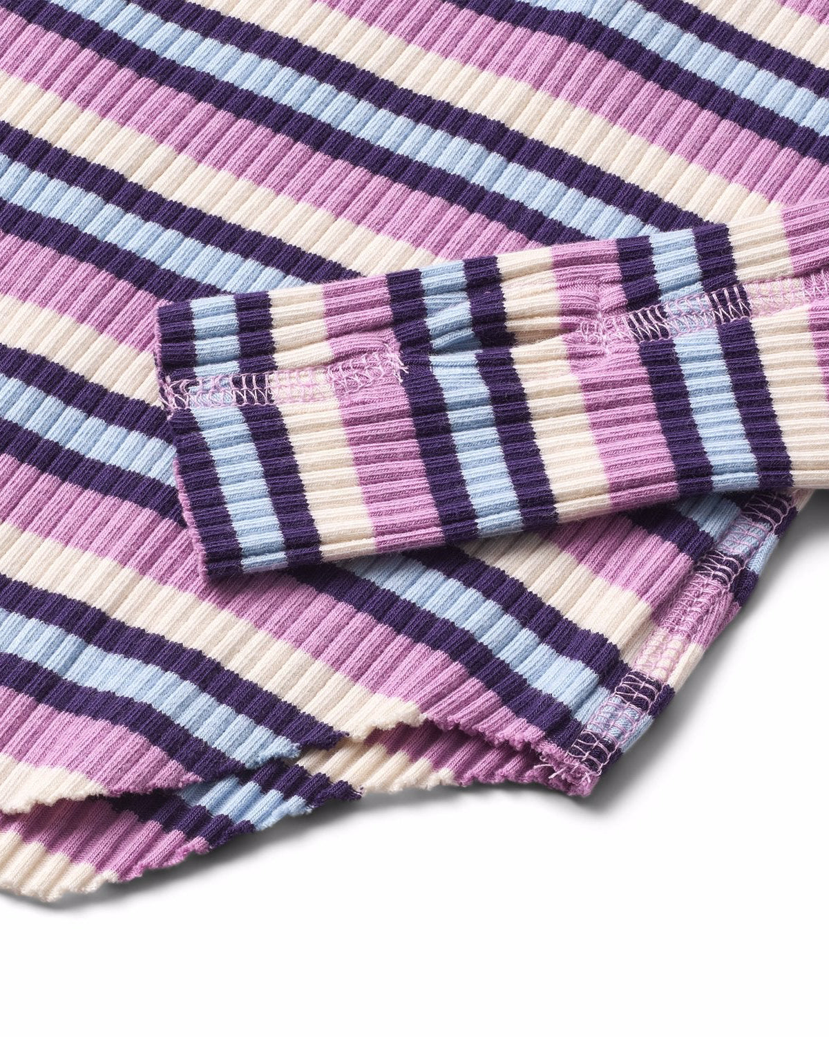 Close-up of a striped fabric with pink, purple, and blue colors on a white background.