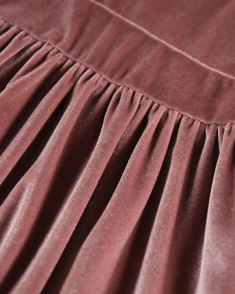 Close-up of a brown velvet fabric with a textured surface.
