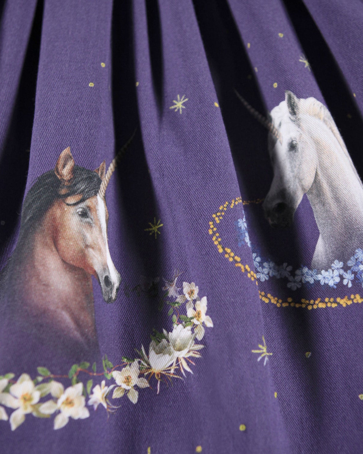 Purple fabric with unicorn and floral pattern