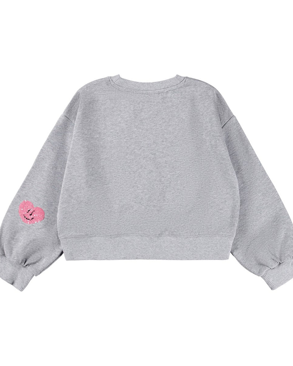 Gray sweatshirt with pink heart design on sleeve against a white background