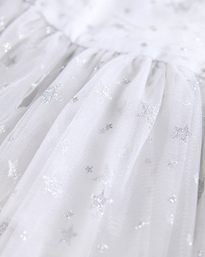 Close-up of a white tulle skirt with star-shaped sequins on a white background