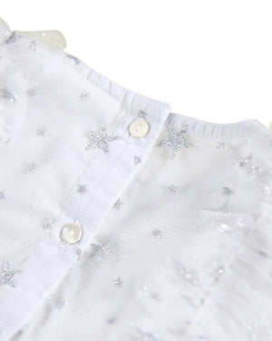 White blouse with star patterns and buttons on a white background