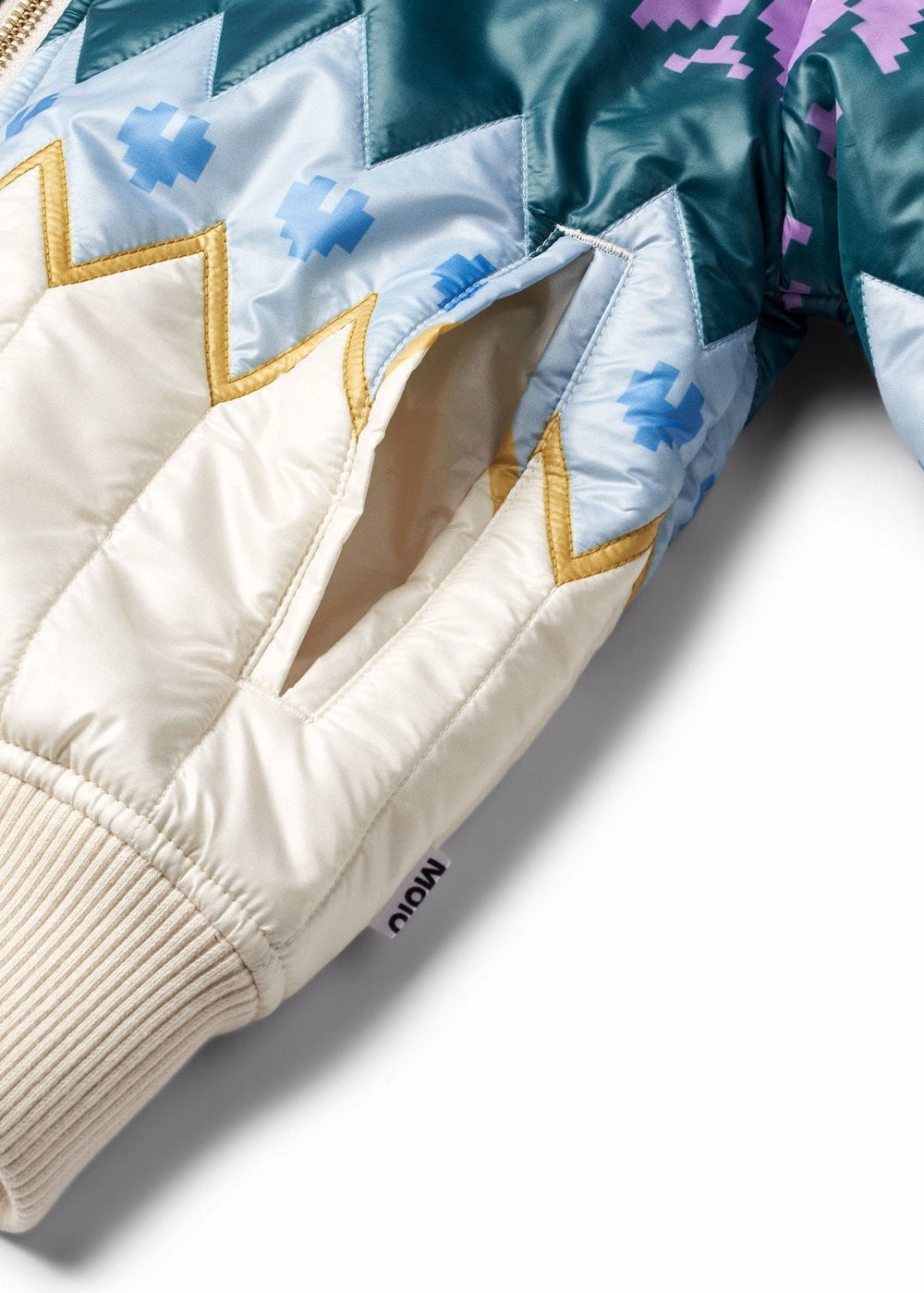 Close-up of a quilted jacket with geometric patterns on a white background