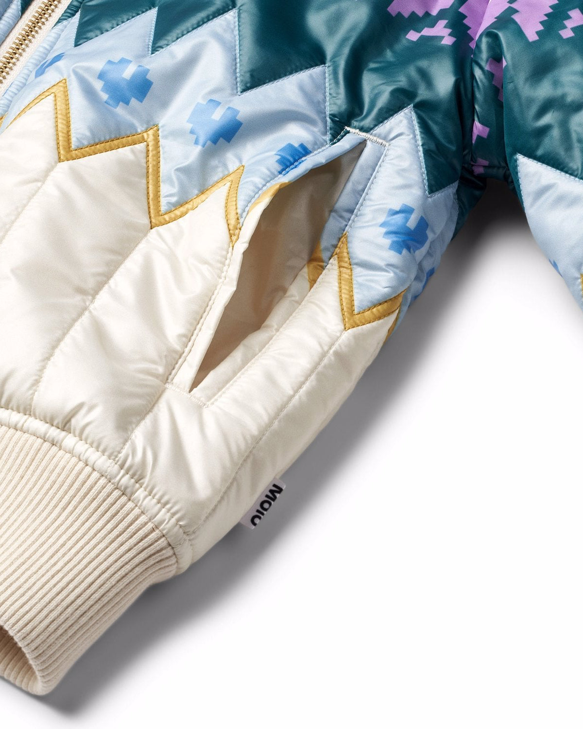 Close-up of a quilted jacket with geometric patterns on a white background