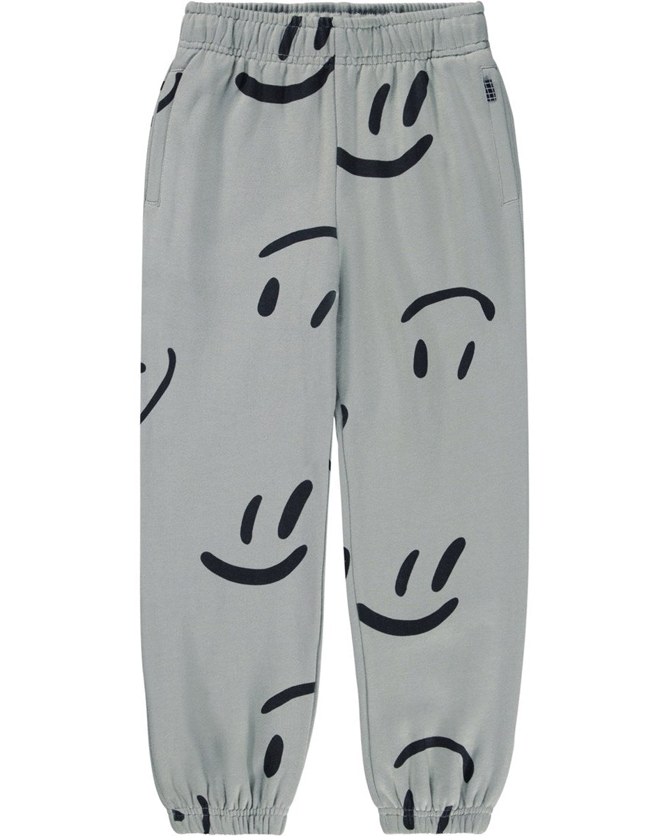 Gray pants with black smiley face patterns on a white background