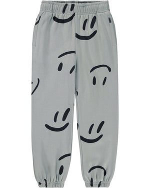 Gray pants with black smiley face patterns on a white background